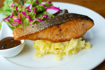 salmon steak with mashed potatoes. Delicious fried salmon fillet with salad beetroot Cooked salmon steak with vegetable. Grilled fresh fish. Fish for healthy dinner. Close-up