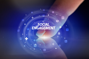 Finger touching tablet with social media icons and SOCIAL ENGAGEMENT