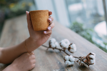Empty waffle Cup for ice cream in hands in cafe.Wafer cup for ice-cream in hand with space for text.advertising waffle Cup.empty cardboard glass with coffee in female hand.