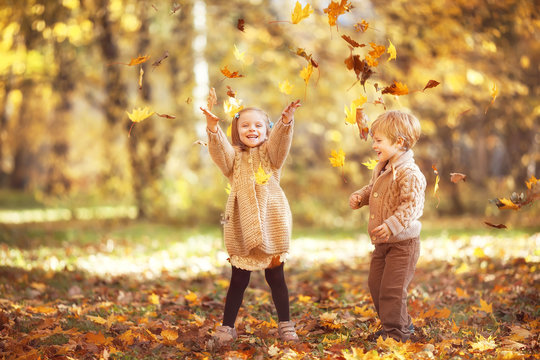 Funny Twins In Autumn Park