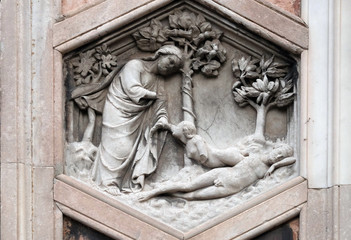 Fototapeta na wymiar Creation of Eve by Andrea Pisano, 1334-36., Relief on Giotto Campanile of Cattedrale di Santa Maria del Fiore (Cathedral of Saint Mary of the Flower), Florence, Italy