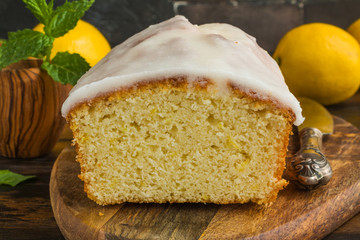 Sweet fruit cake cooked with lemon juice and zest. Wooden rustic table - 291705342