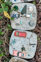 Old toys reused as pavers in the garden.