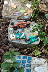 Old toys reused as pavers in the garden.