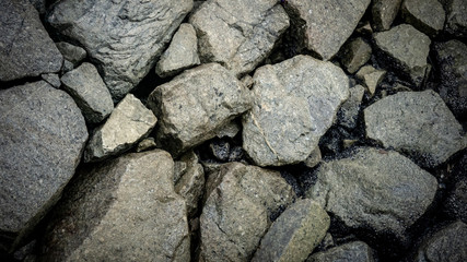 Hard and rough rocks background and texture at the beach.