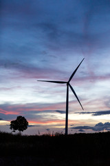 Fototapeta na wymiar Silhouette of wind power station on sunset