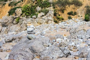 texture of stacked rocks on the beach in gray colors