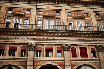 Facade of an old residental Italian brick building in Bologna