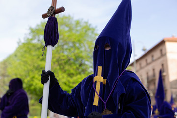 Holding a cross in a procession