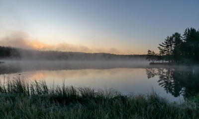 Fototapeta na wymiar Scenic view from swamp , morning landscape with fog over a small forest lake and swamp at autumn morning, frost, beautiful reflections, Driskina lake, Raiskums parish, Latvia
