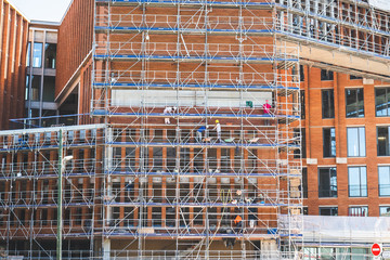 Men working on building construction building with safety equipment