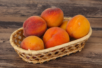 Peach heap in the wooden basket