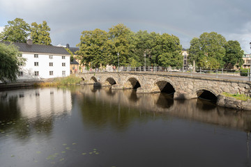 Fototapeta premium Old stone bridge on sunny day with rainbow. Orebro town. Travel photo. Background photo.
