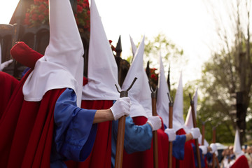 Fototapeta premium Rear view of hood penitents in a procession, Holy Week