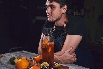Young chef in kitchen preparing juice. Food concept.
