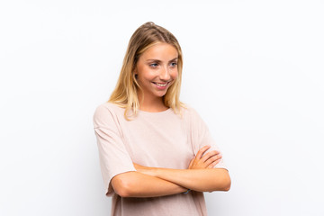 Blonde young woman over isolated white background looking to the side