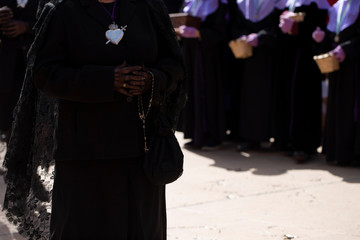 A "manola" is holding a rosary, Holy Week