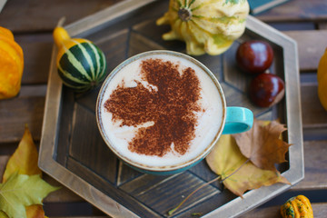 Cup of coffee with cinnamon on an open table