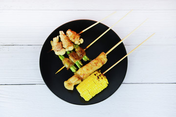 MALA Chinese BBQ - Grilled pork thai asian street food style slice pork with vegetable mushroom corn in skewer sticks grilled on plate with spicy powder chilli