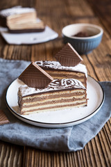 Layered dessert with chocolate cream filling, ornate with powdered sugar