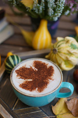 Cup of coffee with cinnamon on an open table