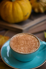 Cup of coffee with cinnamon on an open table