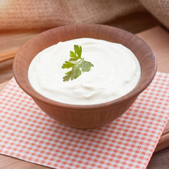 Bowl of Greek yogurt.Delicious breakfast. Homemade yogurt on a wooden tray, top view