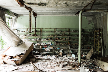 dirty and abandoned library with books on floor in school