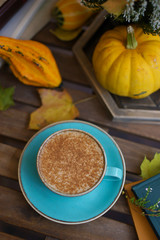 Cup of coffee with cinnamon on an open table