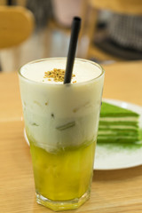 Tasty matcha cake with cold tea for dessert in a Korean restaurant.