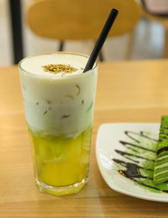 Tasty matcha cake with cold tea for dessert in a Korean restaurant.