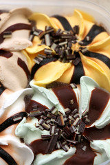 Ice cream with four flavors: pistachio, vanilla, banana and hazelnut. Selective focus.