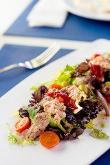 a plate with salad on a table