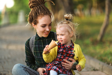 hipster mom and child with ice cream outside