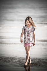 beautiful young girl walking on the beach