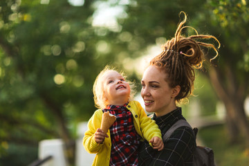 hipster mom and child with ice cream outside