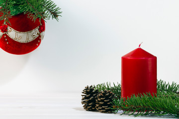 Winter decoration with red candle and christmas ornament on white background, copy space image