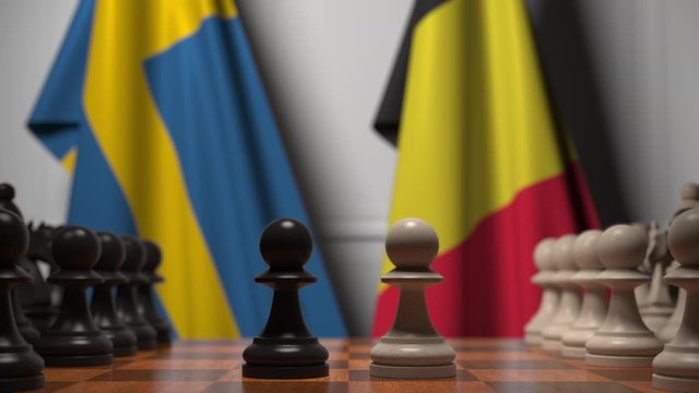 Flags of Sweden and Belgium behind pawns on the chessboard. Chess game or political rivalry related 3D animation