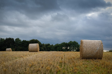 Hay Bales under dramatic sky in late summer