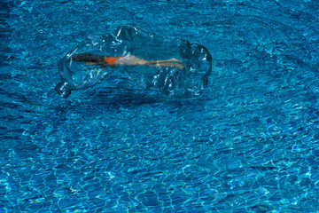 swimming girl inside plastic bottle floating in wave blue ocean water background reflection marine pollution concept