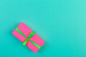 Gift box with ribbon and bow on color background and space for text. Top view - Image