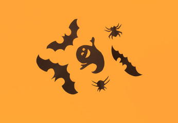 Halloween paper decorations on orange background. Halloween concept. Flat lay, top view, copy space - Image