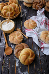 Kaiser rolls on a wooden table closeup