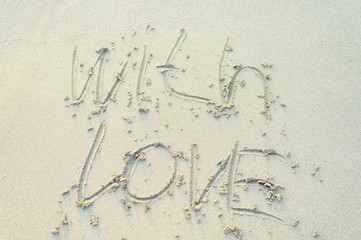 Written letters with love in the sand. Concept of love. Valentines day