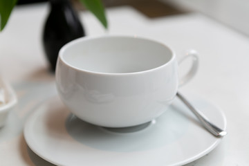 Obraz na płótnie Canvas White empty tea cup in restaurant 