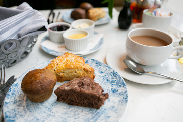 Scones at high tea with mascarpone, lemon curd, and jam