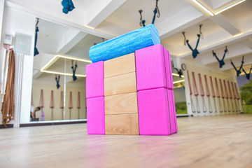 All kinds of Yoga props are on the wooden floor of the yoga studio, props for healthy activities