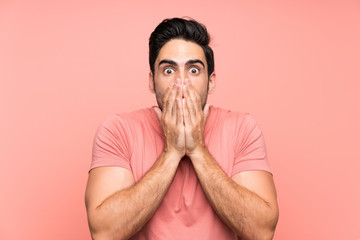 Handsome young man over isolated pink background with surprise facial expression