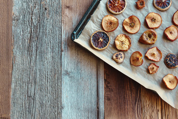 Fototapeta na wymiar Homemade slices of dried apples and oranges (flat lay, copy space)