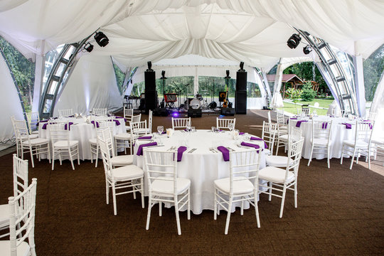 Interior Of A Event Tent Decoration Ready For Guests. Served Round Banquet Table Outdoor In Marquee